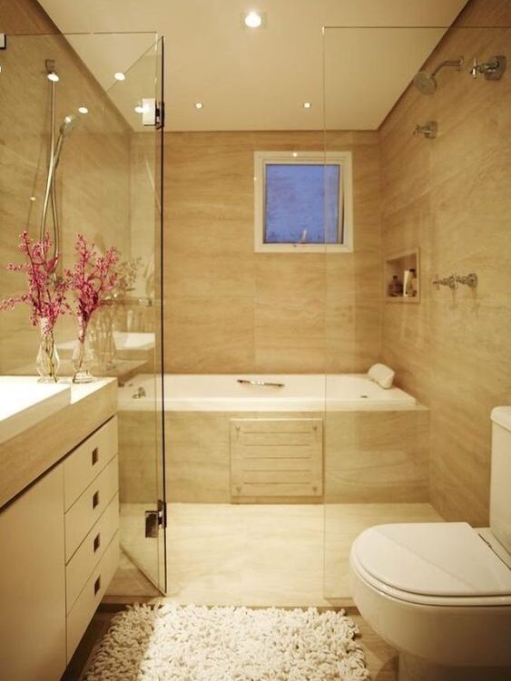 Drop-in tub finished with travertine marble matching flooring and walls