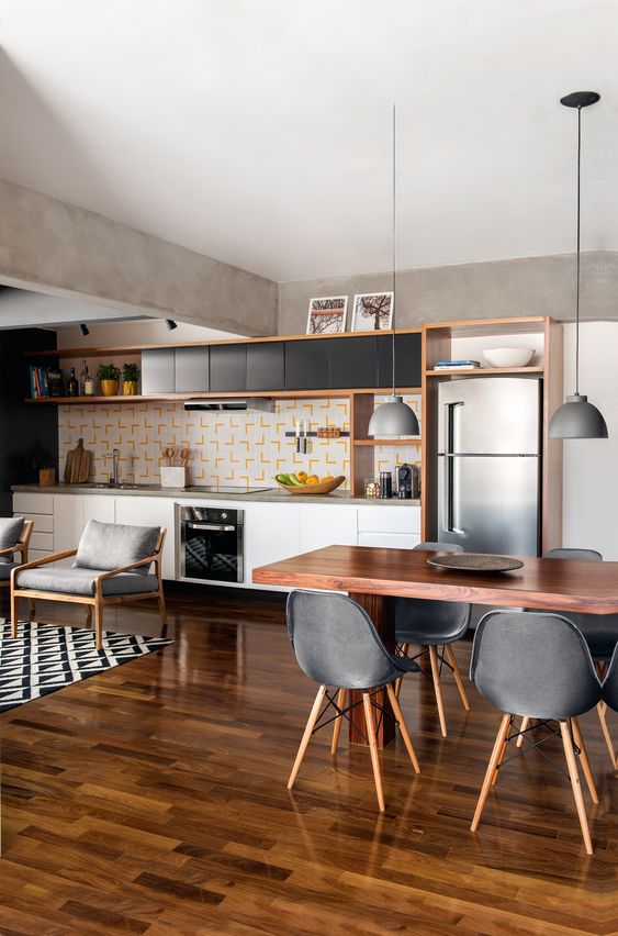 Fully integrated kitchen with living room with hardwood flooring in the whole area