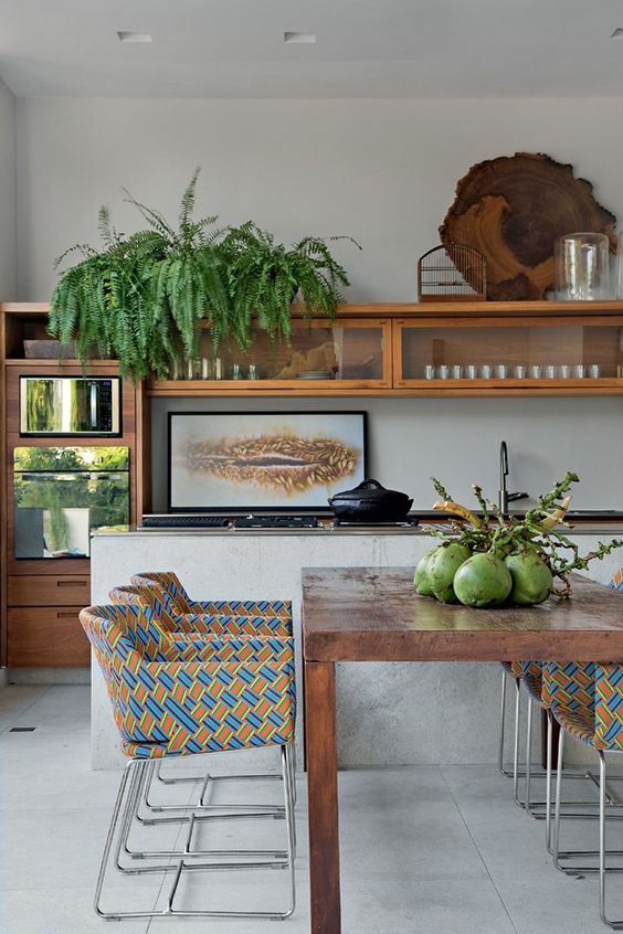 Kitchen separated from living room by an island countertop. Porcelain tiles in both environments. 