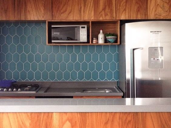 Blue geometric tiles on kitchen walls - countertop with two different parts - marine edge around the sink