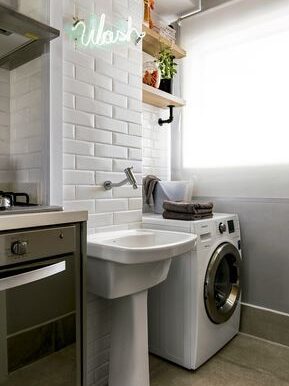 Laundry wall-mounted single hole faucet and free-standing sink.