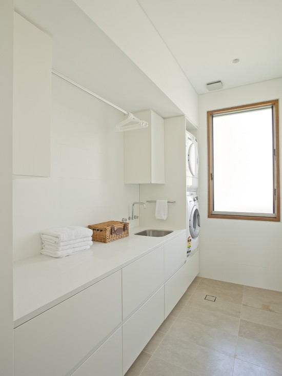 Wall-mounted kitchen faucet in laundry room. 