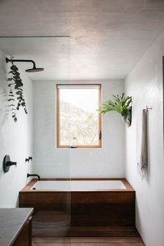 Drop-in tub finished with wood matching the flooring