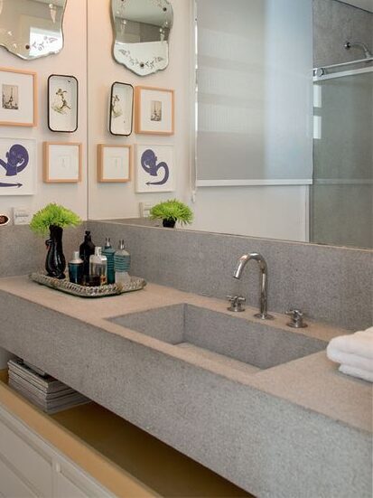 Widespread deck-mounted bathroom faucet and sculpted sink.